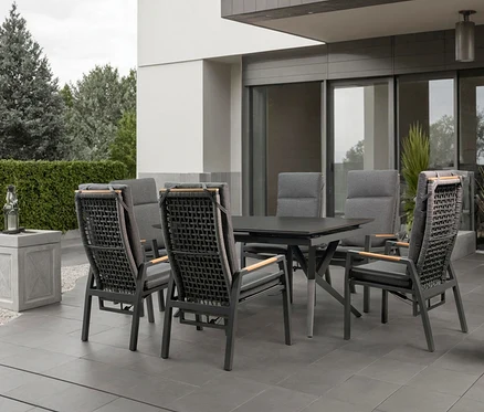 Gartentisch mit sechs Stühlen auf einer Terrasse.
