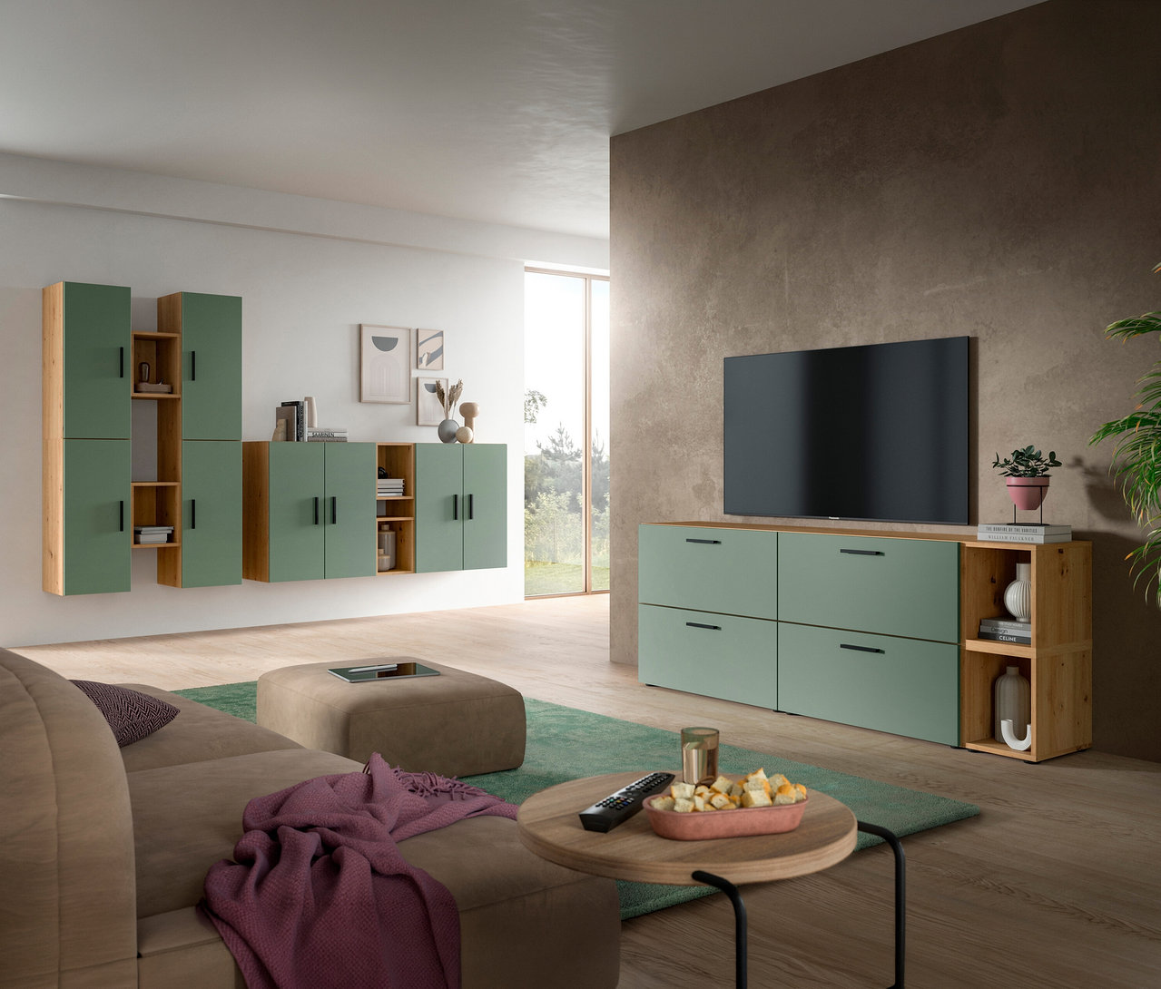 Modernes Wohnzimmer mit der xonox Wohnkombination »The One« in Grün und Holz an einer hellen Wand, einem passenden TV-Möbel mit Fernseher an einer dunklen Wand, einem beigen Sofa, einem Hocker und einem runden Couchtisch auf einem grünen Teppich.
