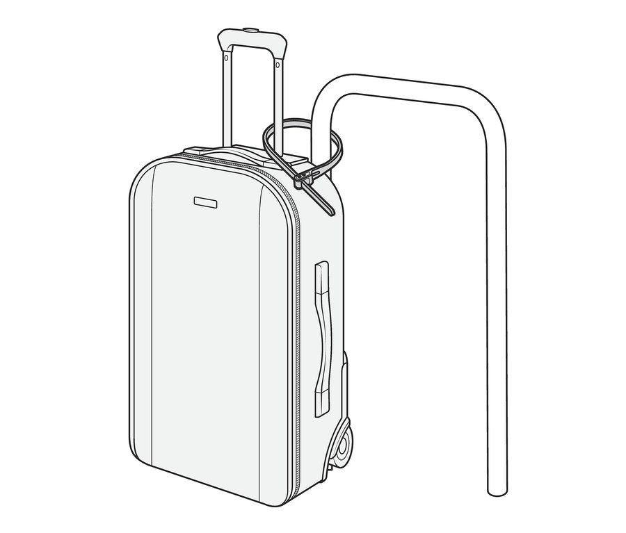 Ein Koffer ist mit einem Kabelbinderschloss an einem Metallrahmen befestigt.