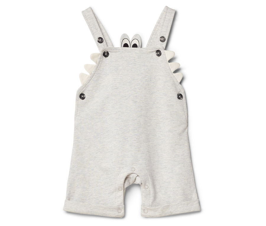 Heller Baby-Jumpsuit mit Trägern, Knöpfen und Krokodil-Design.