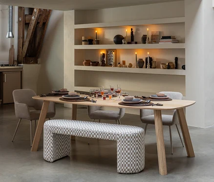 Ein gedeckter WOOOD Tisch »Tablo«, ca. 180 x 100 cm, naturfarben, mit Stühlen und einer karierten Bank in einem Esszimmer. Auf den Regalen brennen Kerzen.