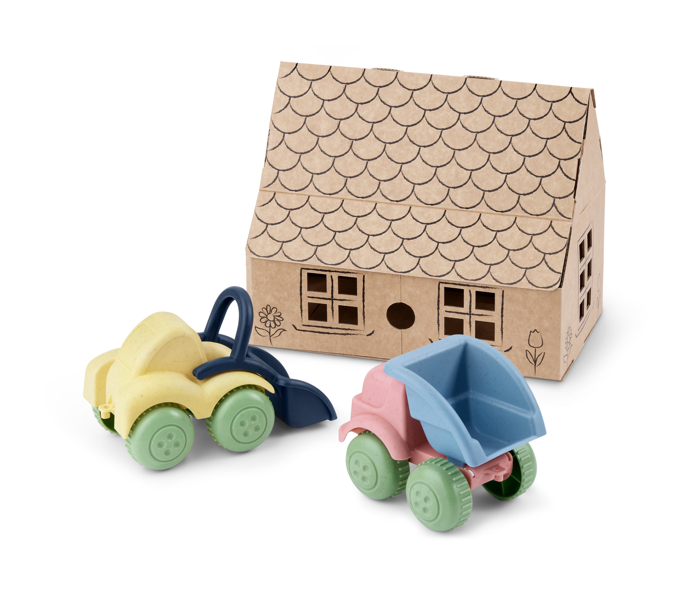 Gelber Kipplaster und blauer Bagger vor einem Papphaus.