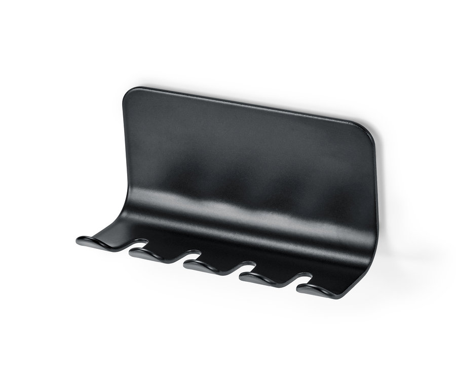 Schwarzer Zahnbürstenhalter an einer weißen Wand.