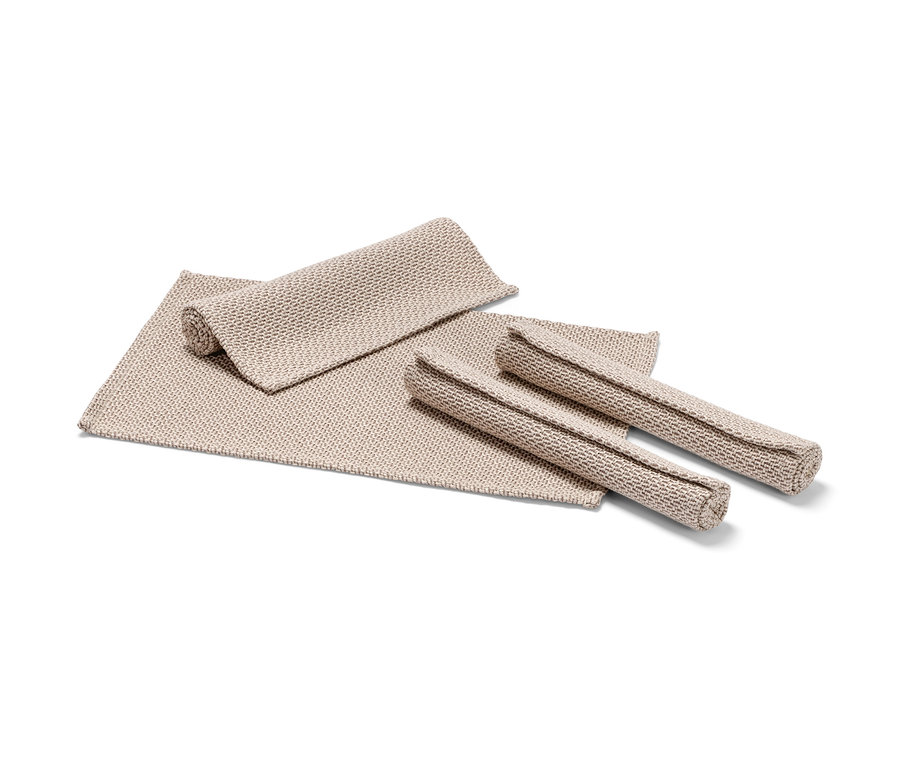 Vier beige Platzsets.