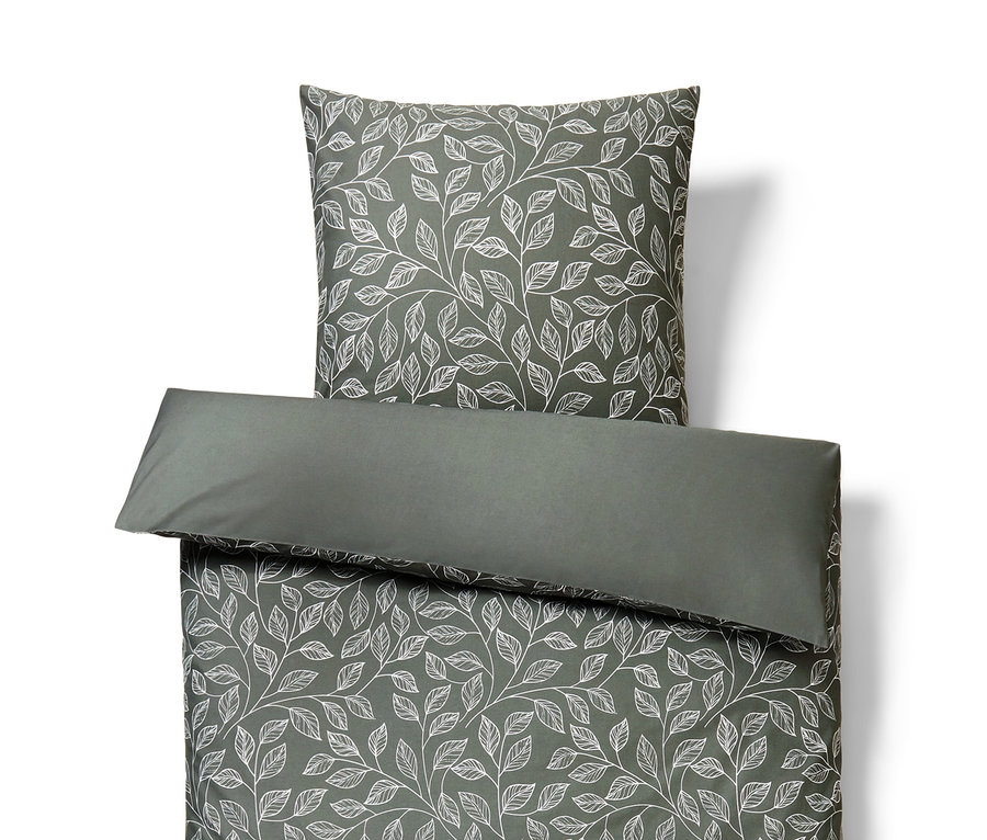 Graue Bettwäsche mit weißen Blättern.