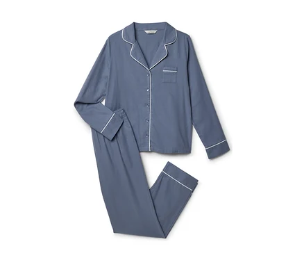 Blauer Pyjama mit langen Ärmeln und Hose, weißer Paspelierung an Kragen, Ärmeln und Hosenbeinen.
