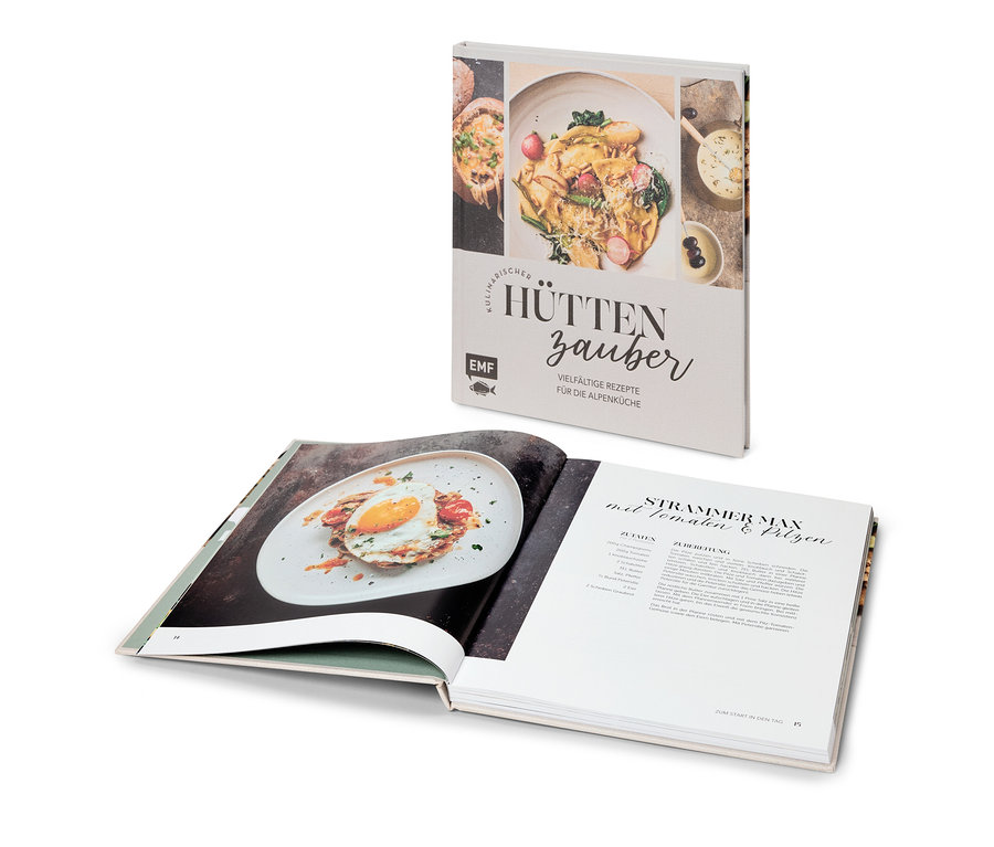 Aufgeschlagenes Kochbuch mit Rezept für "Strammer Max" und Buch "Kulinarischer Hüttenzauber" dahinter.