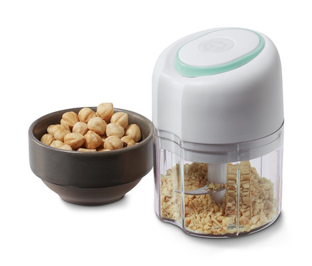 Eine Schale mit Nüssen neben einem kabellosen Multizerkleinerer.