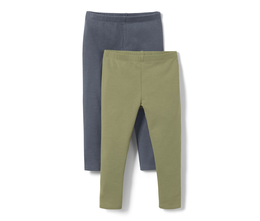 Zwei Baby-und-Kleinkind-Leggings, eine blaue und eine olivgrüne, liegen übereinander.