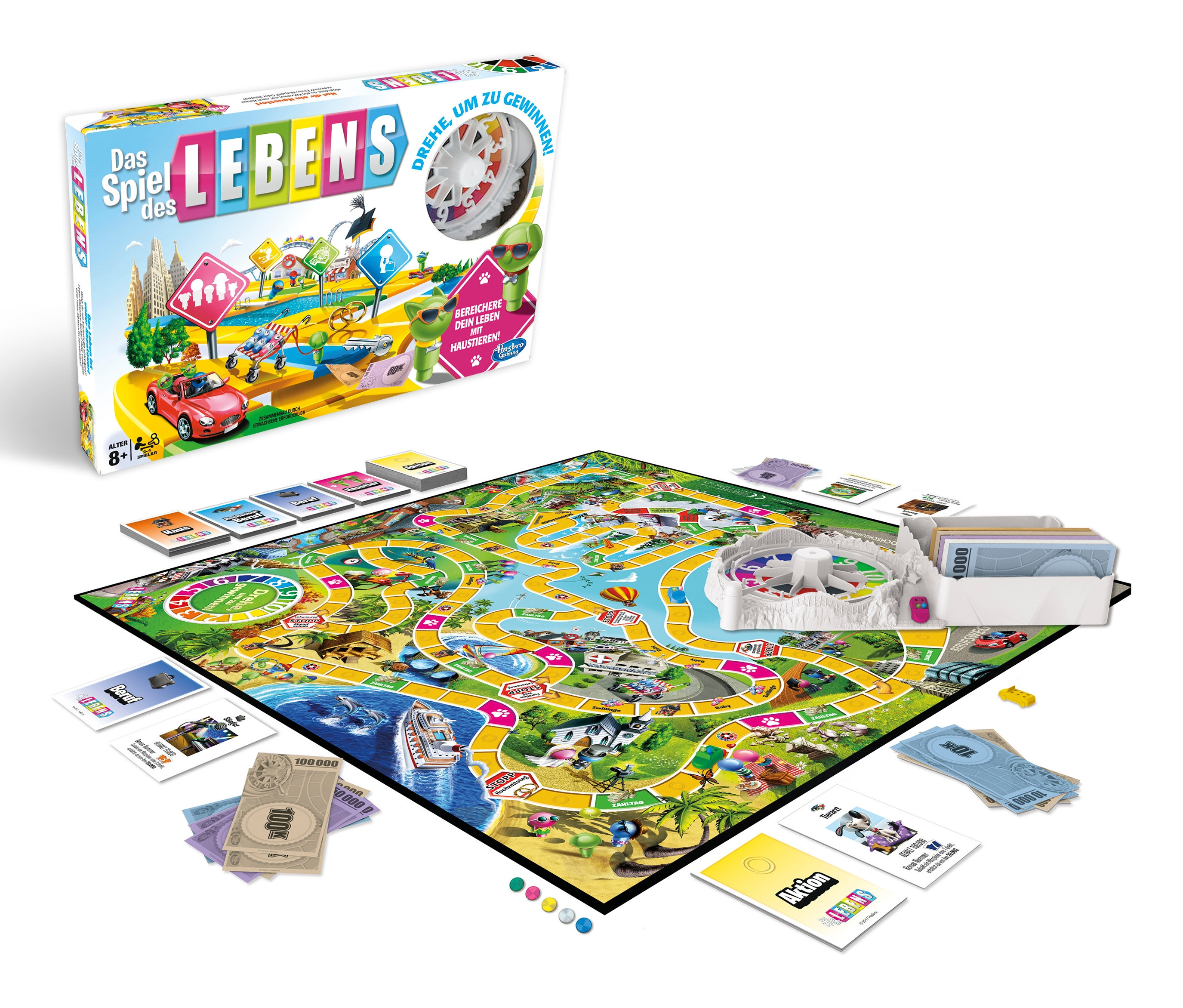 Spielbrett und Schachtel von Hasbro »Das Spiel des Lebens« mit Karten und Spielgeld auf weißem Hintergrund.