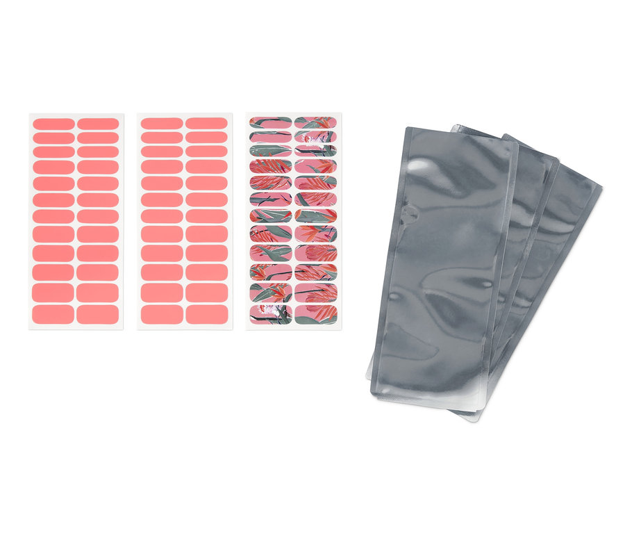 Zwei Bögen mit rosa, selbstklebenden Nagelfolien und ein Bogen mit Blumenmuster. Daneben liegen drei silberne Verpackungen.