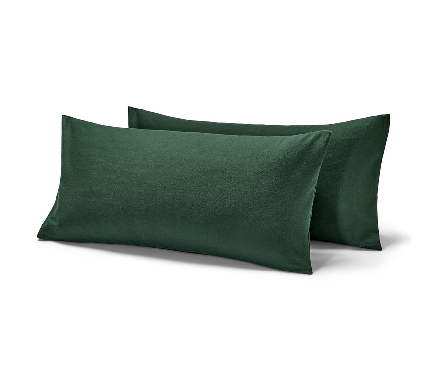 Zwei grüne Biber-Kopfkissenbezüge liegen übereinander.