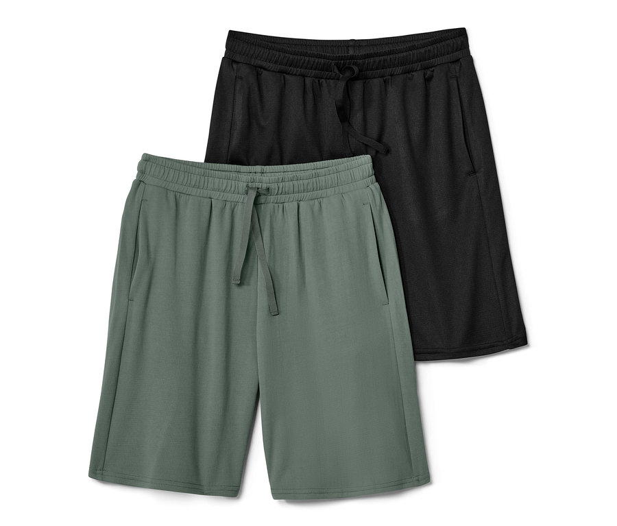 Zwei Kinder-Sportshorts: eine schwarze und eine grüne.