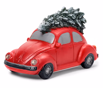 Ein rotes Volkswagen Beetle Modellauto mit einem Weihnachtsbaum auf dem Dach.
