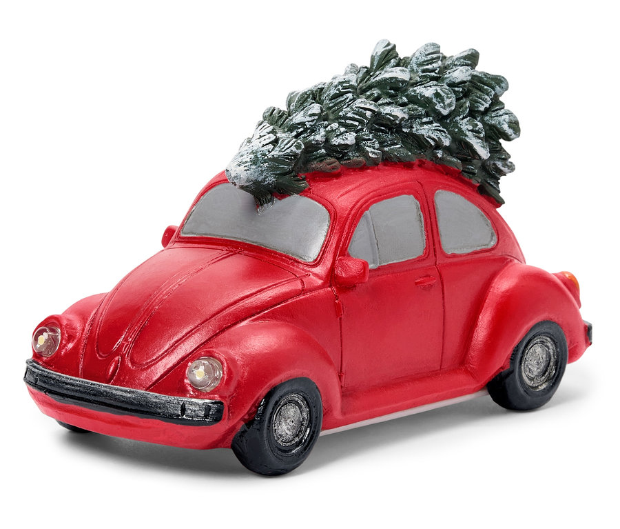 Ein rotes Volkswagen Beetle Modellauto mit einem Weihnachtsbaum auf dem Dach.