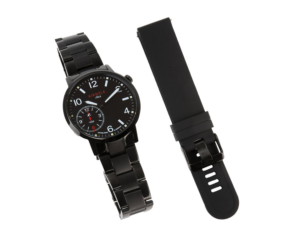Schwarze Uhr mit Metallarmband und schwarzes Kautschukarmband auf weißem Hintergrund. Die Uhr hat ein schwarzes Zifferblatt mit weißen Markierungen und roten Akzenten.