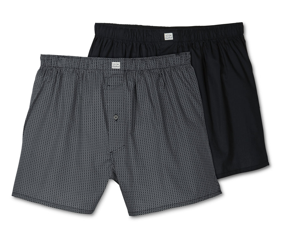 Zwei Web-Boxershorts, eine grau gemustert, eine schwarz.