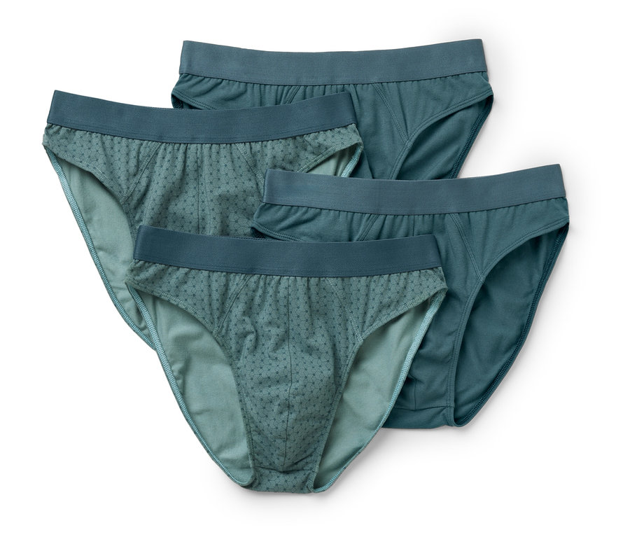 Vier Herrenslips in Blautönen auf weißem Hintergrund.