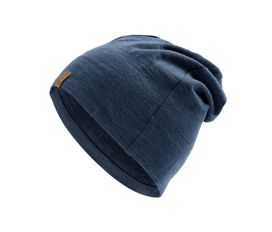 Eine blaue Mütze aus Merinowolle liegt vor einem weißen Hintergrund.