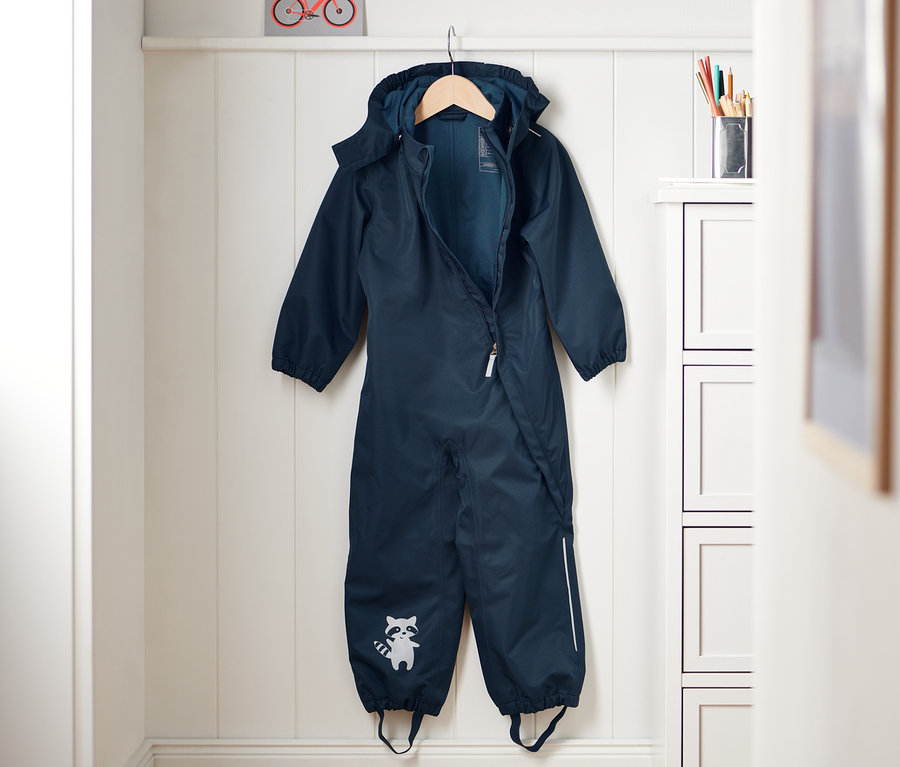 Blauer Regen-Einteiler hängt an einem Kleiderbügel.