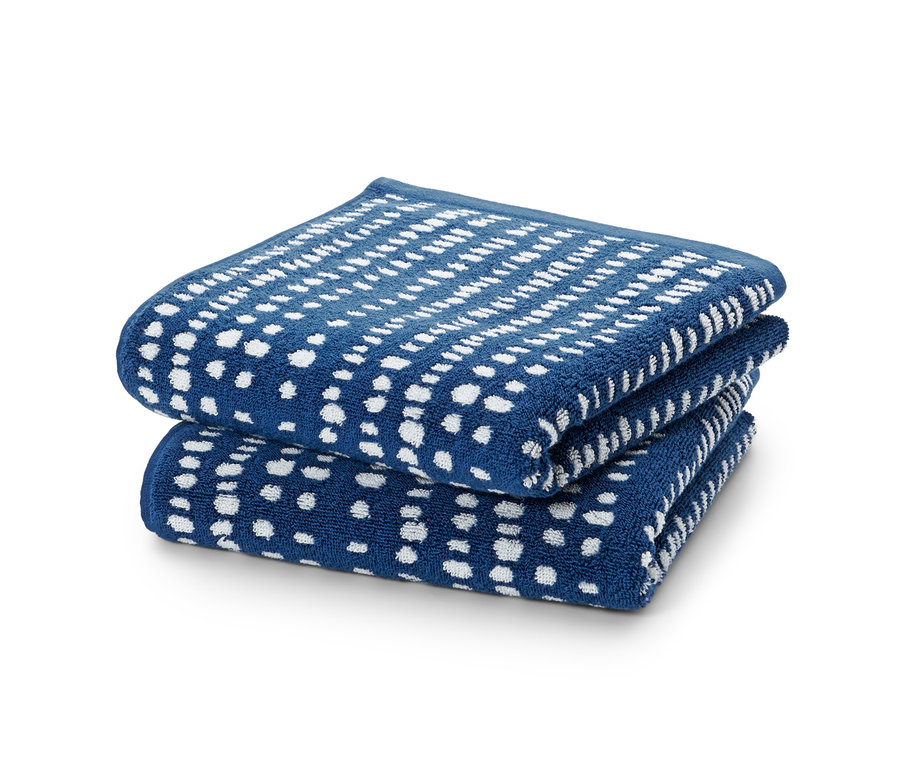 Gestapelte 2 Jacquard-Handtücher mit blauem Hintergrund und weißen Tupfen.
