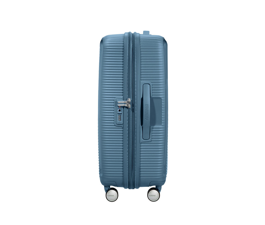 Detailansicht eines mittelgrossen, blauen American Tourister Hartschalen-Koffers »Soundbox« Spinner.