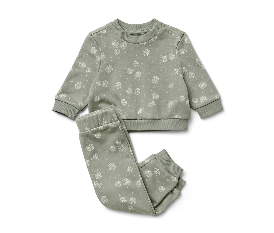 Ein grünes Sweat-Kombi mit weißem Löwenzahn-Print.