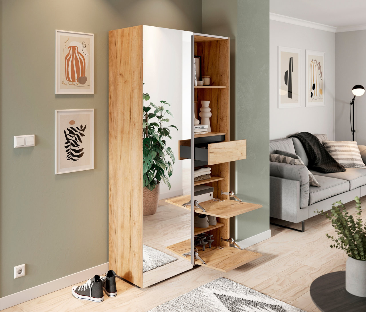 Geöffneter »Aledo« Kompaktgarderobe mit Spiegel, Fächern und Schublade neben zwei Turnschuhen und zwei Bildern im Wohnzimmer.