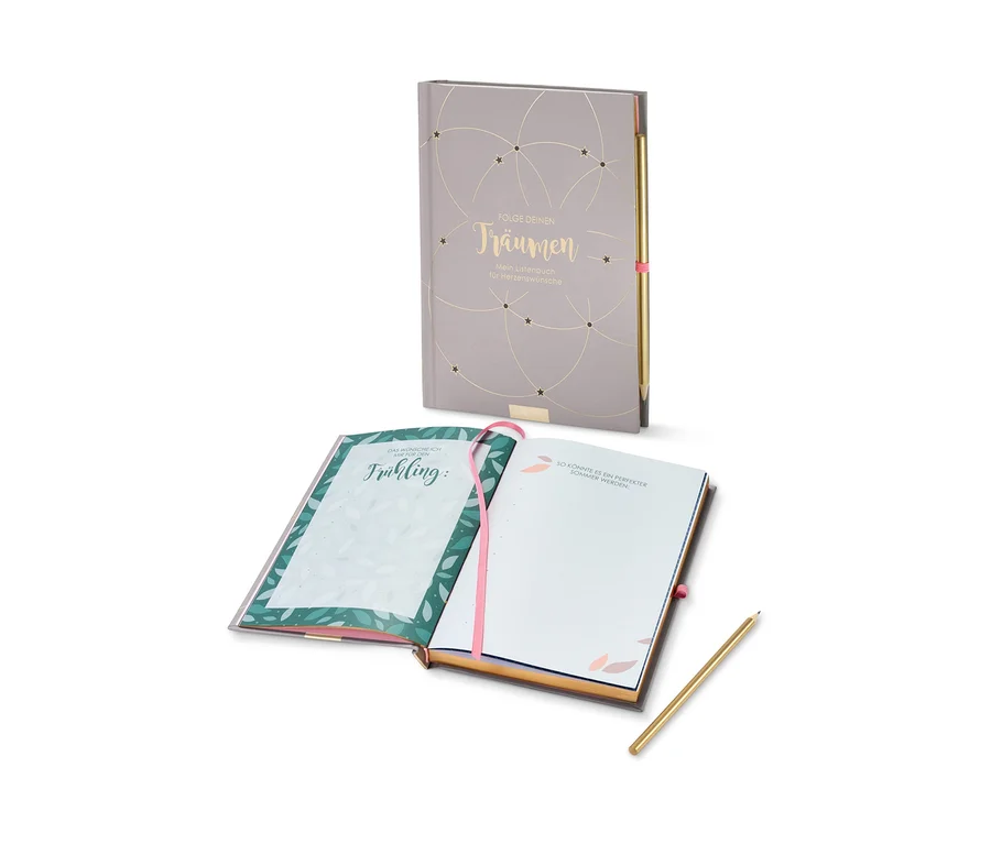 Zwei offene graue Notizbücher »Folge deinen Träumen« und ein goldener Stift.
