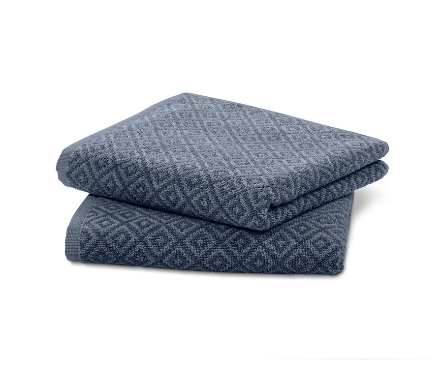 Zwei Jacquard-Handtücher liegen gefaltet übereinander.