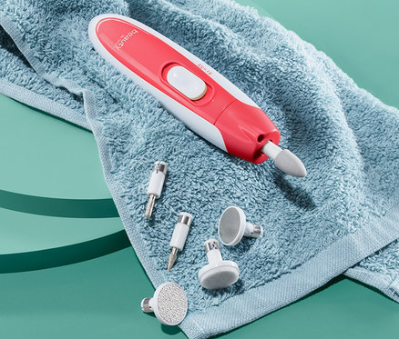 Auf einem blauen Hintergrund liegt ein blaues Handtuch, auf dem ein Maniküre- und Pediküre-Gerät und mehrere Aufsätze liegen.