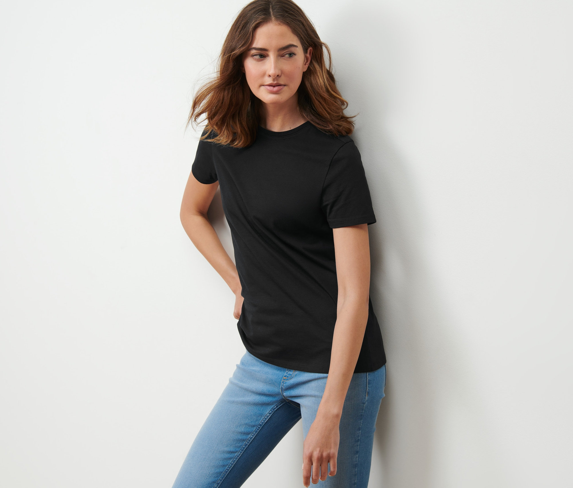 Frau posiert in schwarzem T-Shirt.