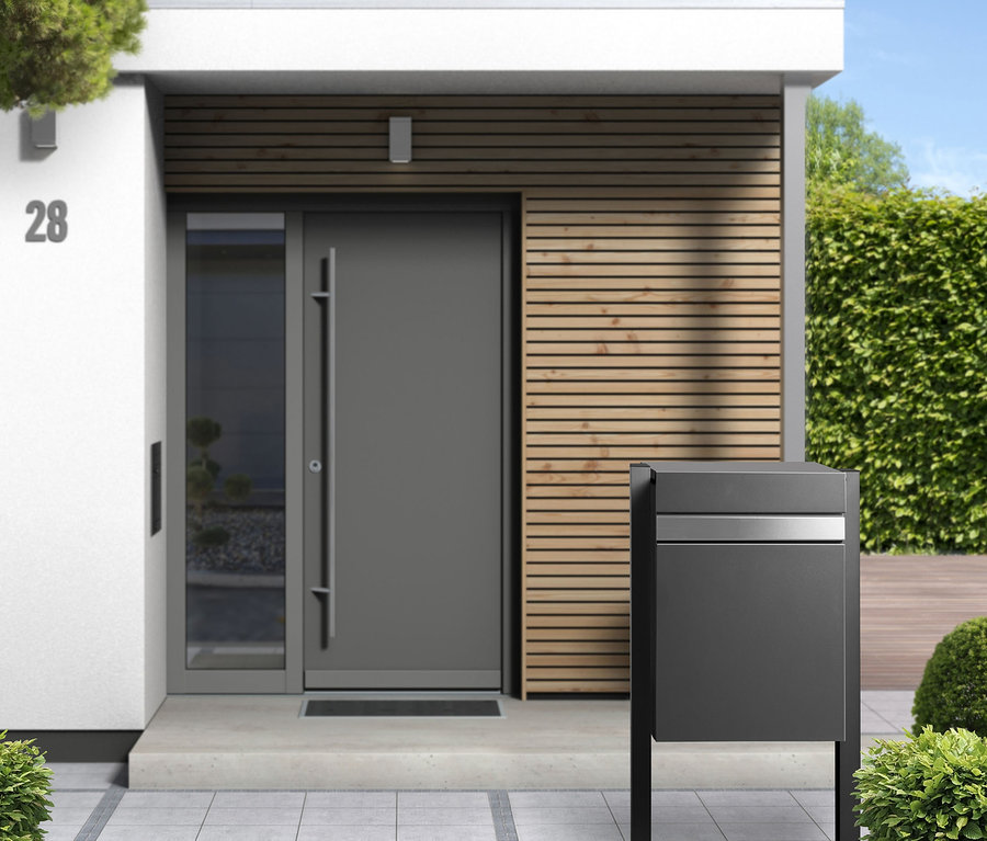 Eingangsbereich eines Hauses mit grauer Tür und Paketbox-Halterung »Luxury«.