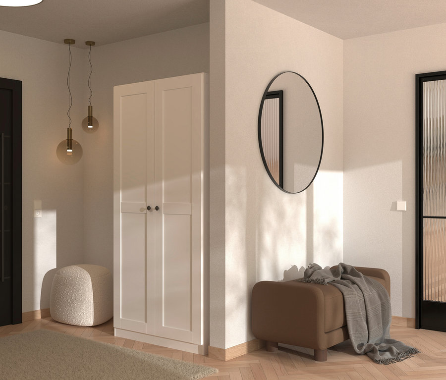 Eingangsbereich mit weißem Schrank, rundem Spiegel, braunem Hocker mit Decke und beigem Teppich auf hellem Holzboden.