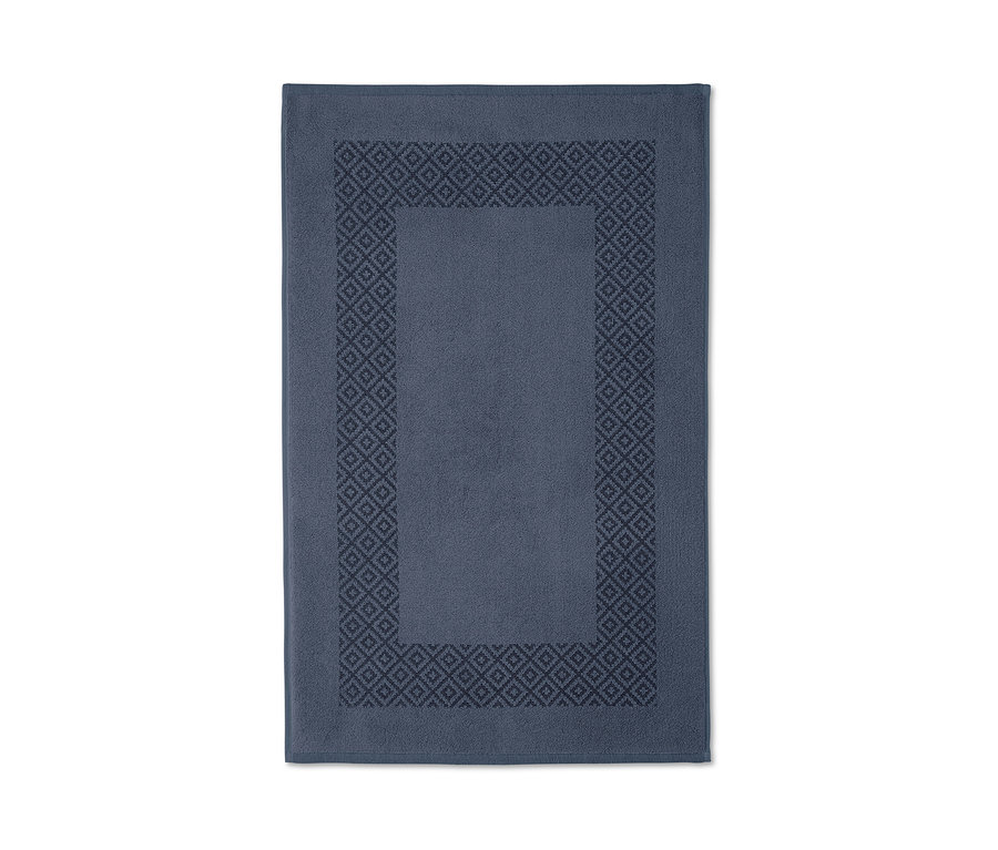 Blauer Wende-Duschvorleger mit geometrischem Muster liegt auf einem weißen Hintergrund.