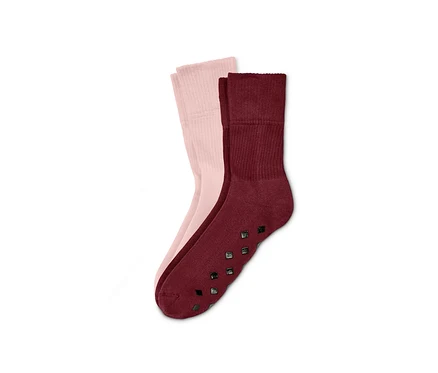 Zwei Paar Stoppersocken: ein Paar ist rosa, das andere bordeauxrot.