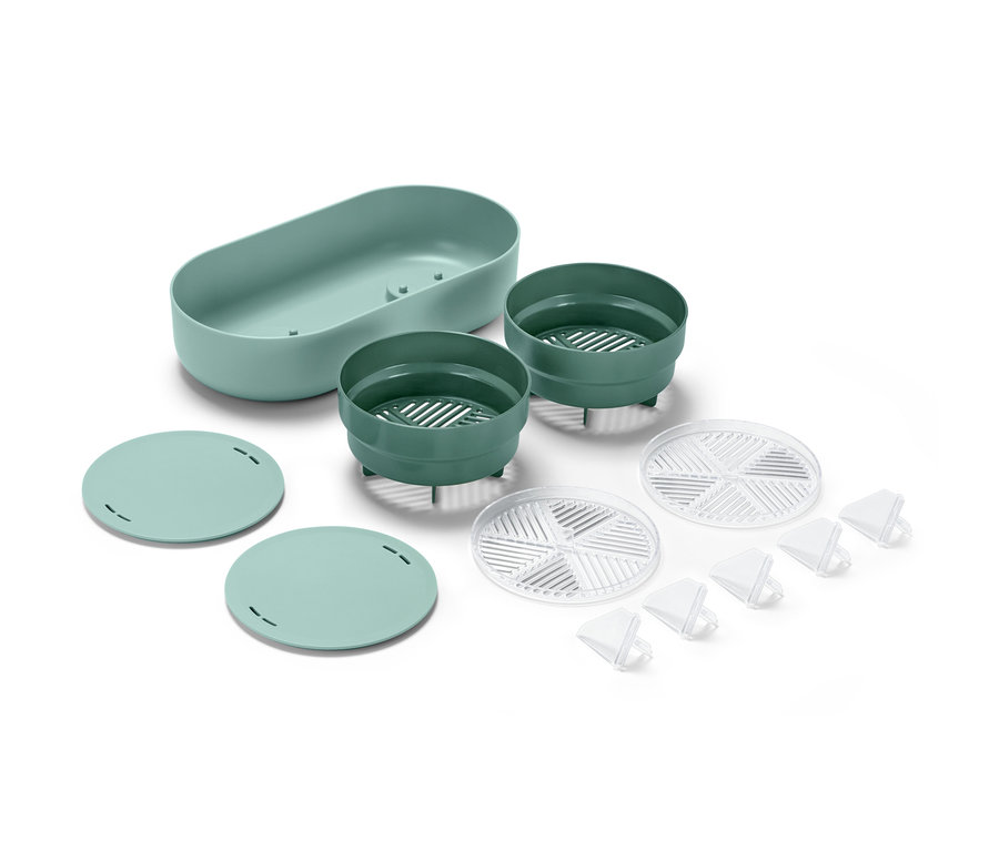 Darstellung des Regrow-Sets: eine hellgrüne, ovale Schale, zwei dunkelgrüne Schalen mit Schlitzen, zwei hellgrüne, runde Deckel, zwei durchsichtige Gitter und fünf durchsichtige, dreieckige Stifte.