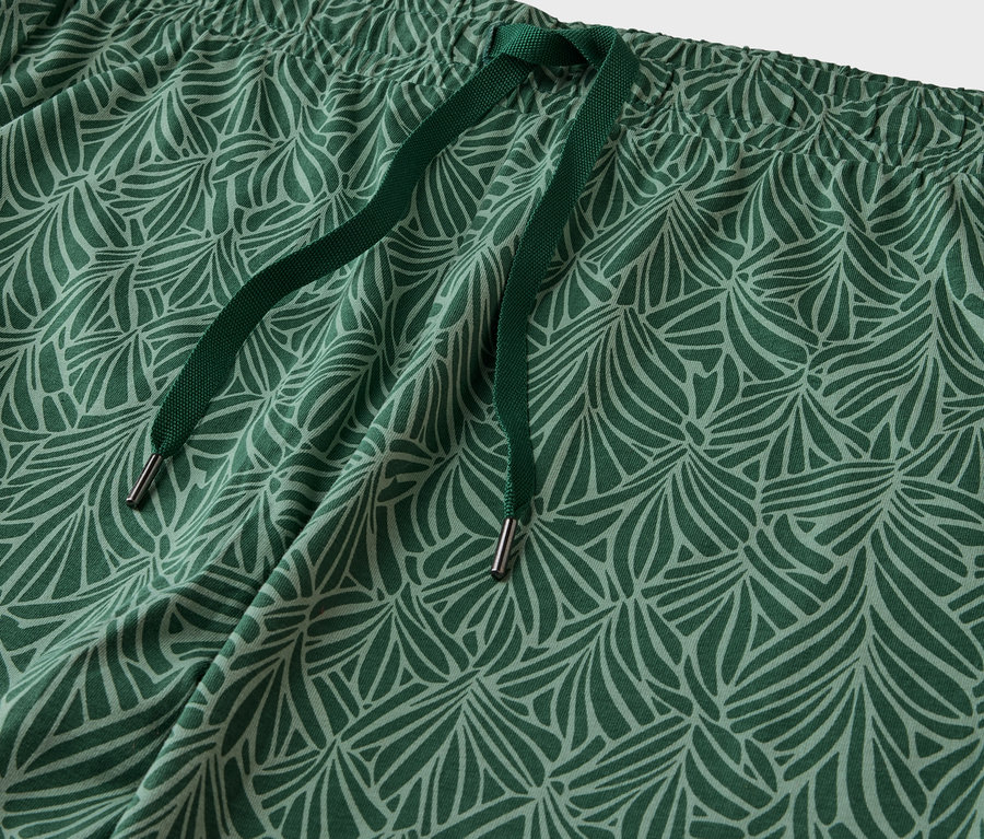 Detail einer grün gemusterten Hose mit Kordelzug.
