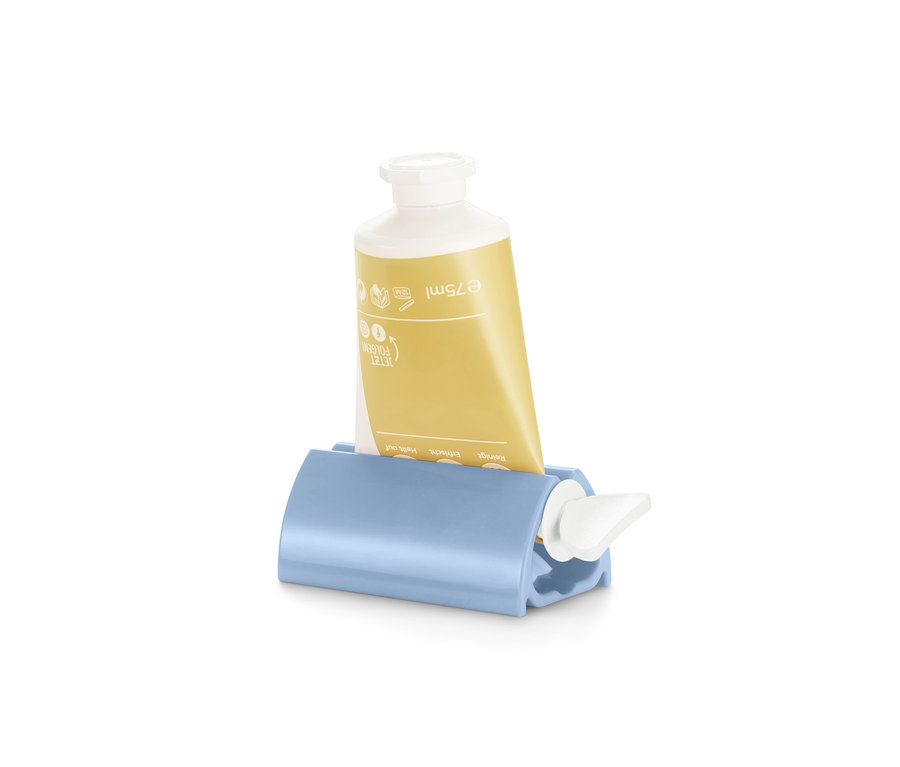 Gelbe Tube in einem blauen Tubenpresser.
