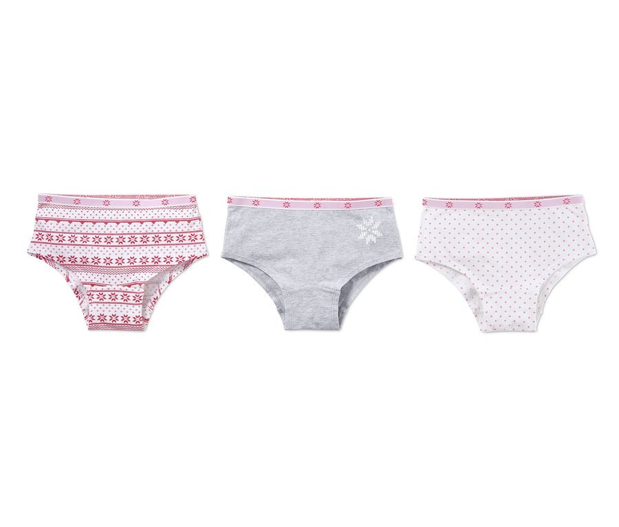 Drei Pantys: Eine mit rotem Muster, eine graue mit weißer Schneeflocke und eine weiße mit roten Punkten.