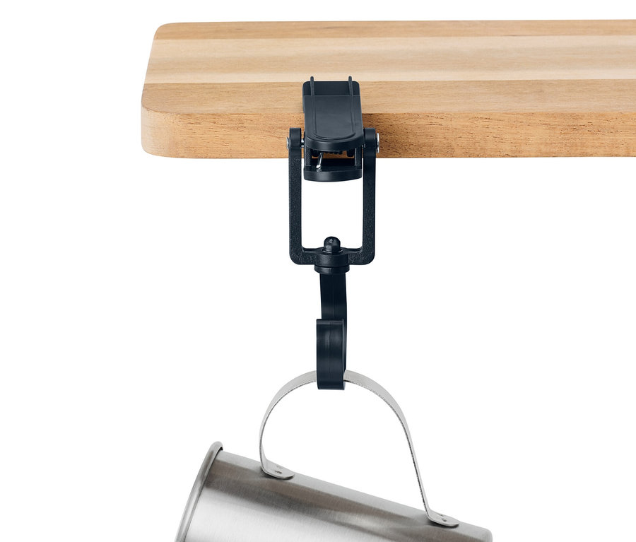 Eine silberne Tasse hängt mit 6 Outdoor-Clips an einer Holzkante.