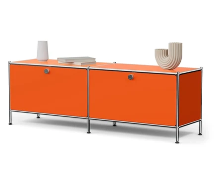 Orangefarbenes Metall-Lowboard »CN3« mit zwei Klappenfächern, darauf eine Vase und ein Buch.