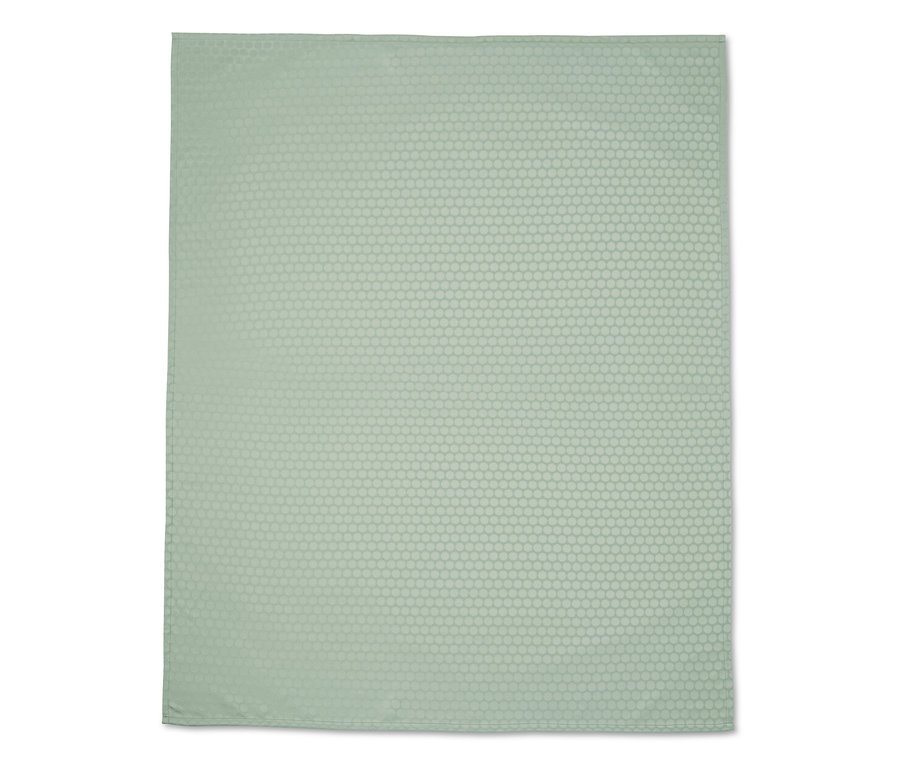 Ein hellgrünes Jacquard-Tafeldecke mit einem Punktmuster.