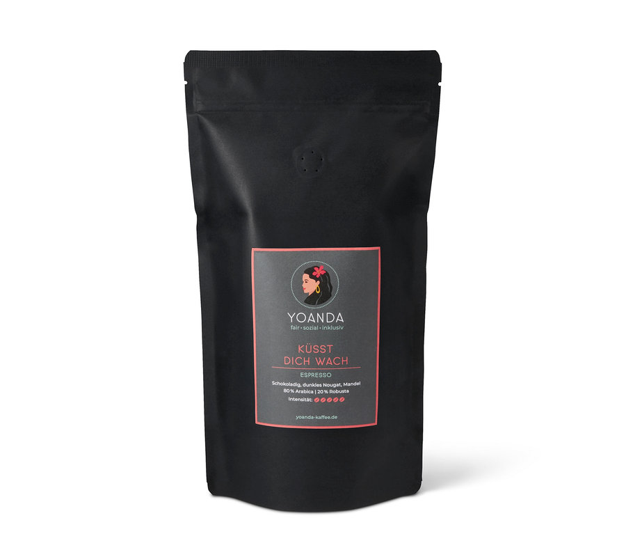 Schwarze Packung Yoanda Küsst Dich Wach Espresso, 1 kg ganze Bohne. Auf dem Etikett ist eine stilisierte Frau mit Blume abgebildet.