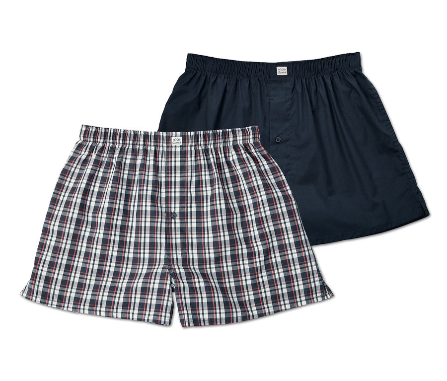 Zwei locker sitzende Webboxershorts, eine kariert, eine marineblau.