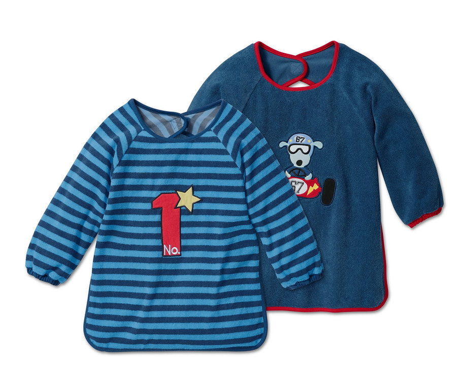 Zwei Ärmellätzchen, eines blau gestreift mit der Nummer 1, das andere dunkelblau mit einem Bären.