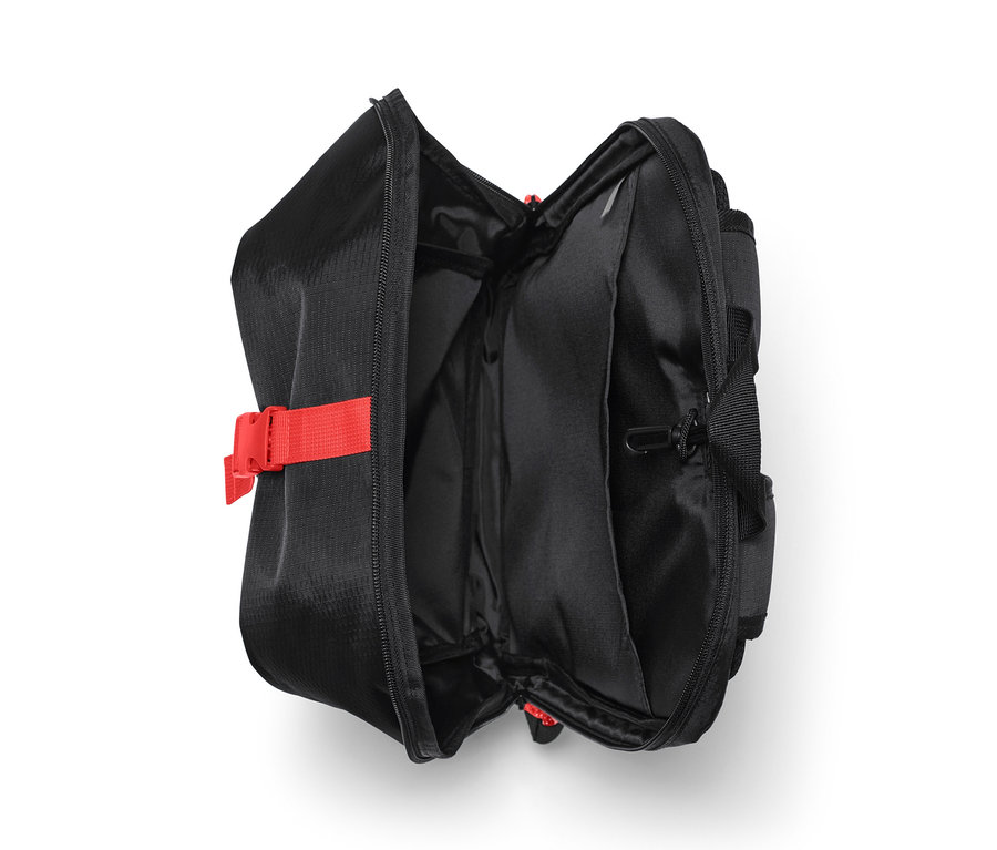 Geöffneter, schwarzer Fahrrad-Rucksack mit rotem Gurt.