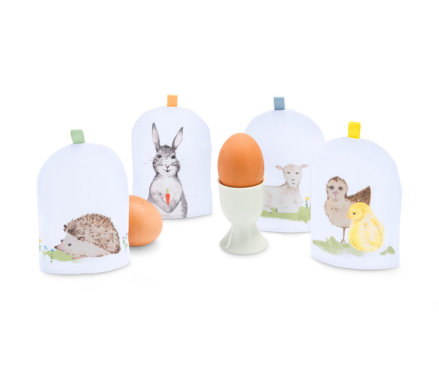 Vier Eierwärmer mit Tiermotiven.