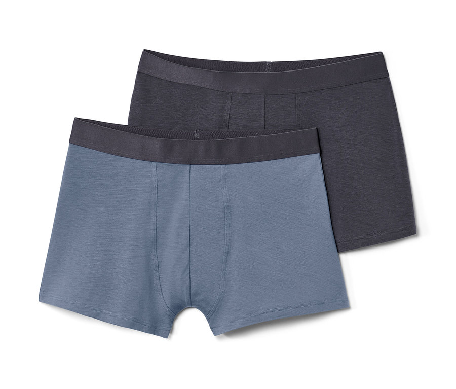 Zwei Slipboxer mit TENCEL™, eine blaue und eine anthrazitfarbene, liegen übereinander.