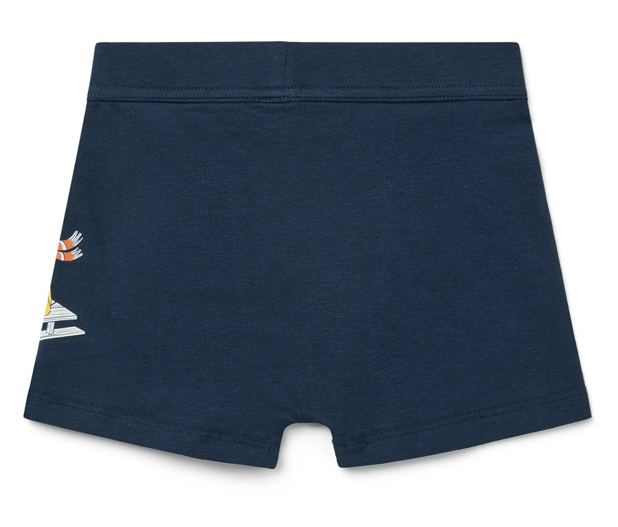 Marineblaue Kinderboxershorts mit Segelboot-Design auf der linken Seite.